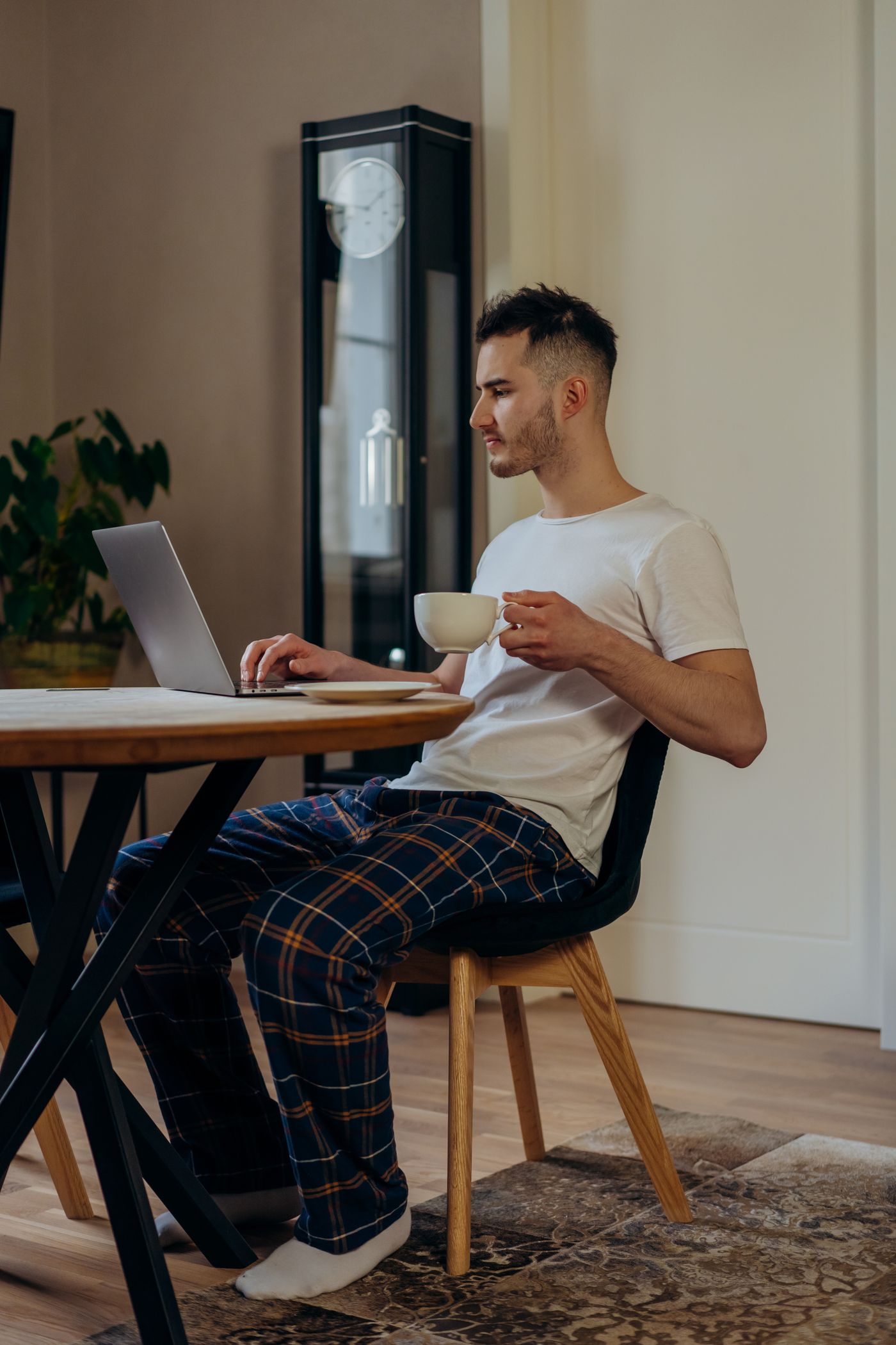A man working through paperwork at his kitchen table